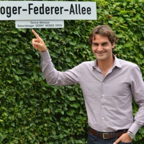 Swiss tennis player Roger Federer poses by a street sign reading his name near the Gerry Weber Stadium in the city of Halle western Germany on June 11, 2012 where the Halle ATP open started today. Federer has won the tournament five times. AFP PHOTO / CARMEN JASPERSENCARMEN JASPERSEN/AFP/GettyImages
